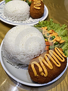 Chicken cordon bleu served with rice and salad