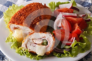 Chicken cordon bleu and vegetable salad closeup. horizontal