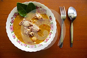 chicken curry or kari ayam served on bowl, isolated on white background.