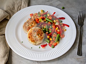 Chicken cutlets with steamed Mix vegetables, Chicken meat balls on white plate. Heathy lunch, diet food. Selective focus, close up