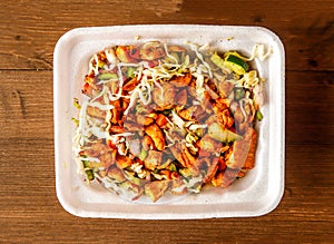 Chicken diet salad with cucumber, cabbage, tomato and onion served in dish isolated on wooden background top view of indian spices