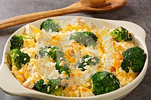 Chicken Divan is a type of chicken and broccoli casserole with a creamy sauce close up in the dish. Horizontal