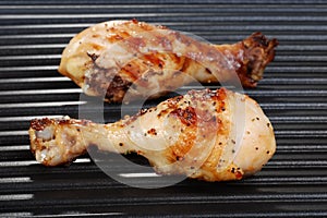 Chicken drumstick on grill photo