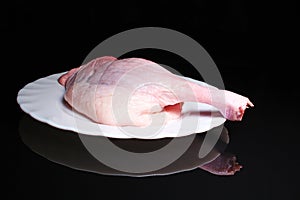 Chicken drumstick meat leg raw food on black reflective studio background. Isolated black shiny mirror mirrored