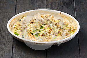 Chicken dumplings with onion sauce baked in oven