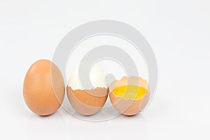Chicken egg is half broken among other eggs.