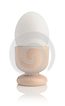 Chicken egg in holder isolated on white