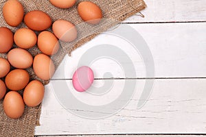 Chicken egg on wood table on sack with preserved egg and space