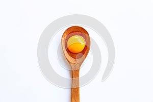 Chicken egg yolk on wooden spoon