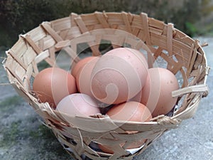 Chicken eggs in a bamboo basket