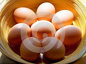 Chicken eggs in bamboo basket.