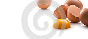 Chicken eggs and broken egg with yolk isolated on white background