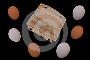 chicken eggs, brown, white, and paper packaging
