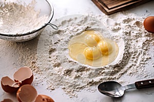 Chicken eggs in flour on the kitchen table, ingredients. Preparation for baking