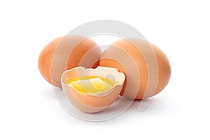 Chicken eggs and half broken egg with yolk  isolated