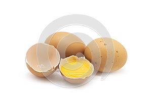 Chicken eggs and half broken egg with yolk isolated on white background