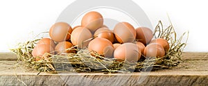 Chicken eggs in hay nest. Isolated. Organic food
