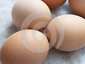 Chicken eggs lie on a fabric surface, close-up. Multi-colored chicken eggs