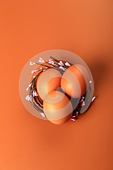 Chicken eggs in a nest on a beige background. Minimalistic Easter concert
