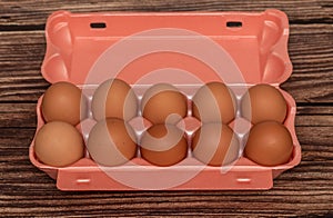 Chicken eggs in a package. On a brown background. Natural product