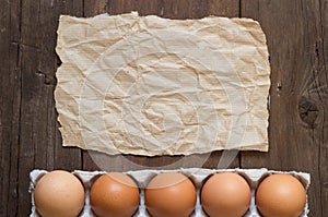 Chicken eggs in the package and paper