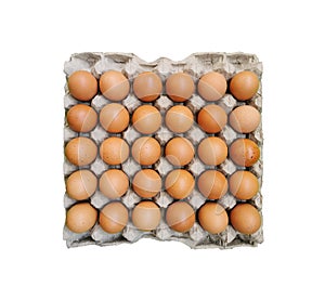 Chicken eggs in paper tray isolated on white background without shadow.Top view of 30 eggs in close-up photo