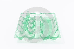 Chicken eggs in a plastic container on a white background