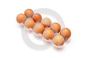 Chicken eggs in plastic package on white.