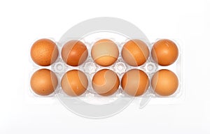 Chicken eggs in plastic package on white.