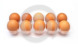 Chicken eggs in plastic package on white.