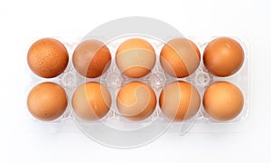 Chicken eggs in plastic package on white.