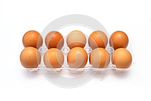 Chicken eggs in plastic package on white.