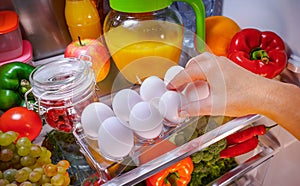 Chicken eggs on a shelf open refrigerator