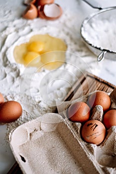 Chicken eggs in a tray on a wooden board. Baking ingredients. Recipe concept