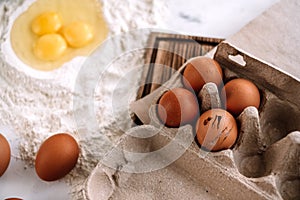 Chicken eggs in a tray on a wooden board. Baking ingredients. Recipe concept