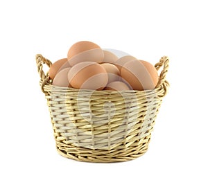 Chicken eggs in wicker basket isolated