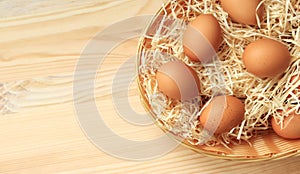 Chicken eggs in a wicker basket, top view