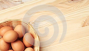 Chicken eggs in a wicker basket, top view