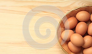 Chicken eggs in a wicker basket, top view