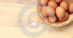 Chicken eggs in a wicker basket, top view