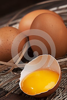Chicken eggs on wooden background close-up