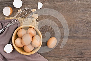Chicken eggs in a wooden bowl Farm fresh organic eggs laid on a rustic wood