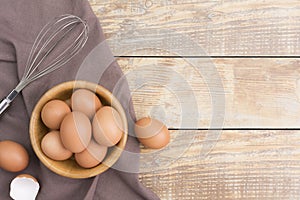 Chicken eggs in a wooden bowl Farm fresh organic eggs laid on a rustic wood