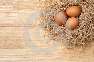 Chicken eggs on wooden table.