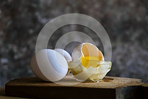 Chicken eggs on a wooden table, on a wooden background. White eggs. Background for the cafe