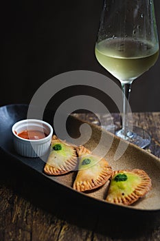 Chicken Empanadas La abuela style pastry puffs, spinach, green chimichurri sauce photo