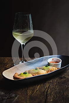 Chicken Empanadas La abuela style pastry puffs, spinach, green chimichurri sauce photo