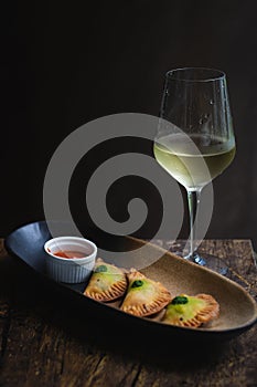 Chicken Empanadas La abuela style pastry puffs, spinach, green chimichurri sauce photo