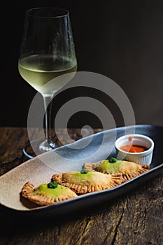 Chicken Empanadas La abuela style pastry puffs, spinach, green chimichurri sauce photo