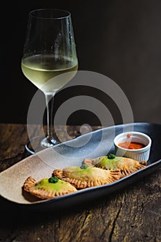 Chicken Empanadas La abuela style pastry puffs, spinach, green chimichurri sauce photo